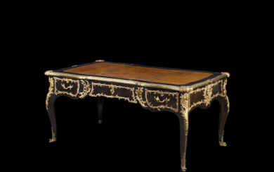 An ebony and rosewood veneered centre desk with gilt-bronze mounts. Sormani, France, late 19th century (cm 173x77x100) Label in a...