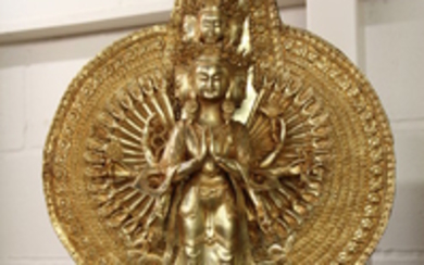 An impressive Tibetan gilt bronze figure of a thousand arm and multi head deity, H. 70cm.
