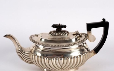 A silver teapot, J & C, Birmingham 1904, of half-ribbed