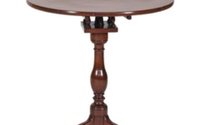 QUEEN ANNE BIRDCAGE TILT-TOP TABLE In mahogany, with circular top, vasiform pedestal and cabriole legs ending in snake feet. Height...
