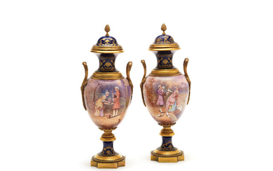 A pair of early 20th century French gilt bronze mounted Sevres style gilt tooled cobalt blue ground porcelain garniture vases and covers