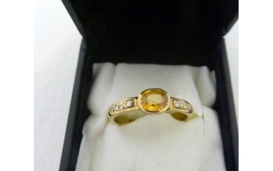 A 18ct yellow gold ring of a central oval deep yellow stone,...