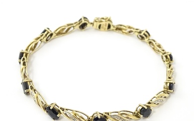 A 9ct gold bracelet set with sapphires and diamonds. Approx....