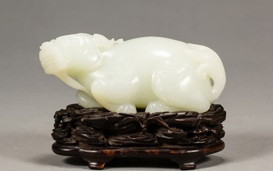 A CHINESE CARVED WHITE JADE MYTHICAL BEAST