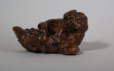 A CHINESE ROOT WOOD 'LION AND CUB' CARVING. Qing Dynasty. Naturalistically formed, the root oriented to resemble zoomorphic shapes of a lion cub jumping up towards his mother, 14cm long. Provenance: English private collection. 清 根雕佛獅擺件 來源：英國私人收藏。