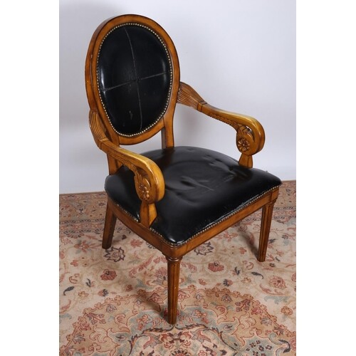 A CONTINENTAL STAINED WOOD AND HIDE UPHOLSTERED ARMCHAIR wit...