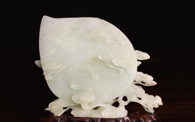 A Chinese Vintage Jade Carving of a Lady with basket of peaches and a fawn carved in relief against