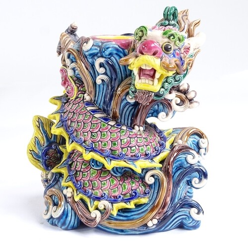 A Chinese glazed ceramic dragon design candle stand, impress...