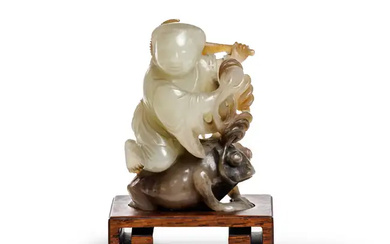 A Chinese two colour jade carving of Liu Hai and his three-legged...