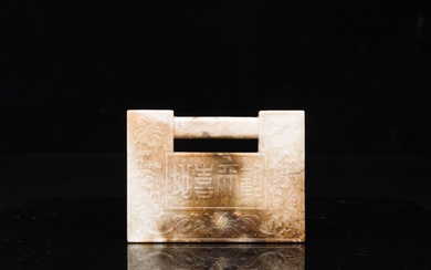 A Chinese white and russet jade lock-shaped plaque with inscription 'Huan Tian Xi Di 歡天喜地',...