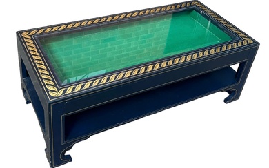 A DESIGNER COFFEE TABLE WITH GLASS INSERT AND GOLD...