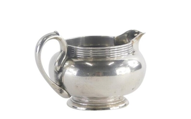 A George V silver milk jug, the top with...