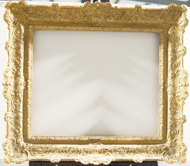 A Gilded Composition Louis XIV Style Frame, mid-late 20th century, with leaf sight, sanded frieze, the cross-hatched ogee with scrolling foliate strapwork and cartouche centres and corners, bell flower demi-centred, dentil back edge, 49.3 x 60 cm...