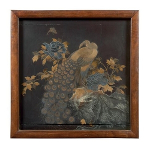 A Japanese black and gilt wood panel with a peacock