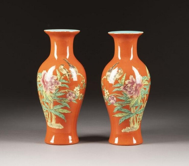A PAIR OF RED-GROUND FAMILLE ROSE BALUSTER VASES