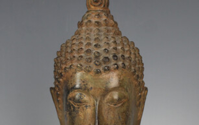 A Thai bronze Buddha head, 19th/20th century, modelled with tightly curled hair rising to a domed un