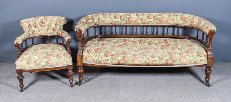 A Victorian Walnut Framed Tub-Shaped Settee, with spindle turned...