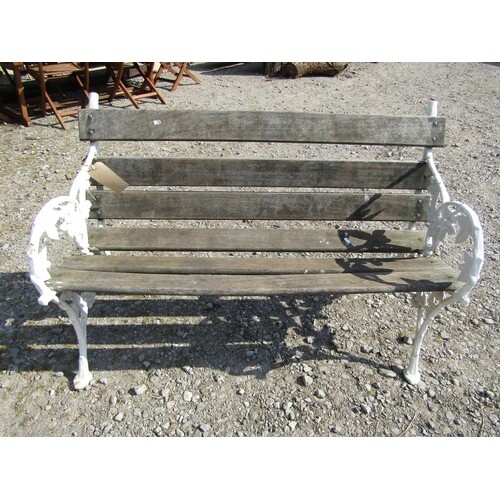 A Victorian style cast iron and teak garden bench with black...