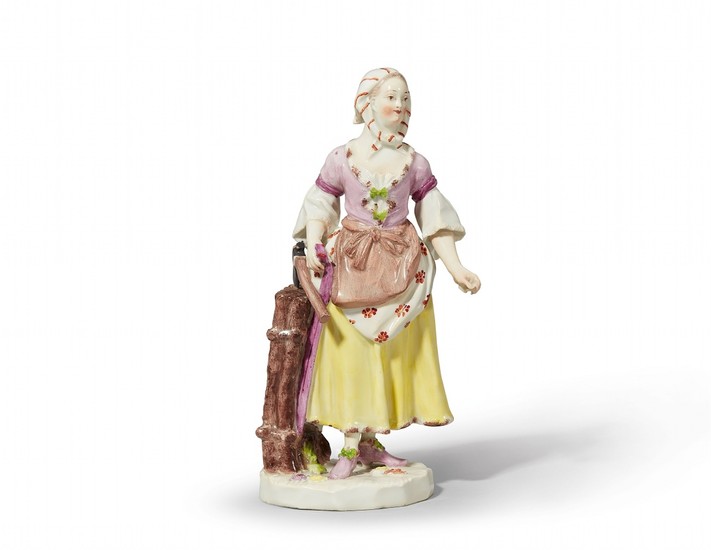 A Vienna porcelain figure of a girl carrying wood