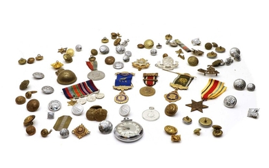 A collection of military badges buttons and medals