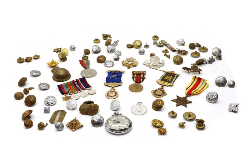 A collection of military badges buttons and medals