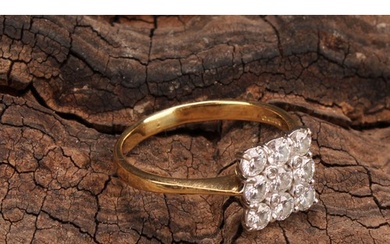 A diamond cluster ring, square set with nine round brilliant...