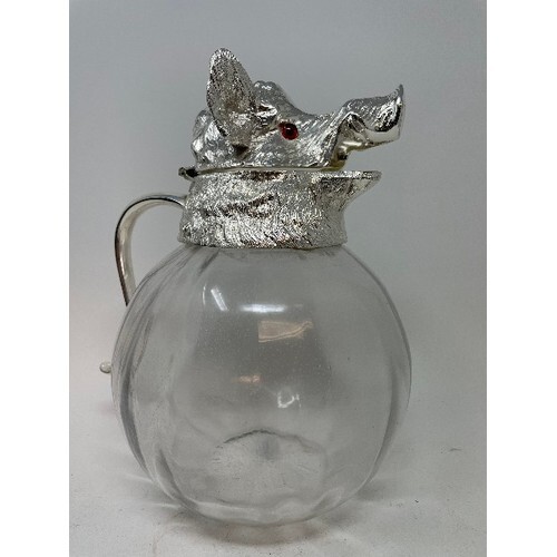 A glass Pimms or lemonade jug, with boar head plated mounts,...