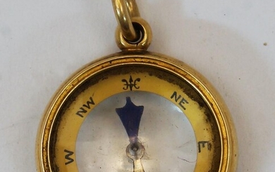 A gold fob compass, late 19th century, stamped 18ct, with suspension loop, 2.6cm diameter, gross weight approx. 11.3g