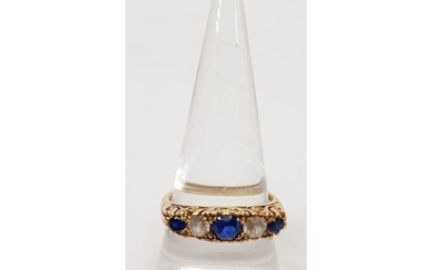 A hallmarked 9ct gold ring set with sapphire and clear stone...