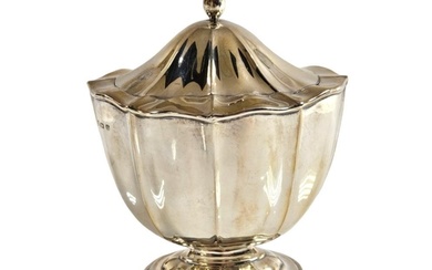 A hallmarked silver pedestal tea caddy with fluted decoratio...