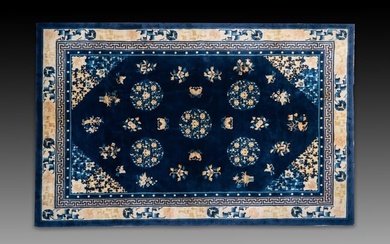 A large Chinese dark-blue-ground carpet with flowers and butterflies, 19/20th century
