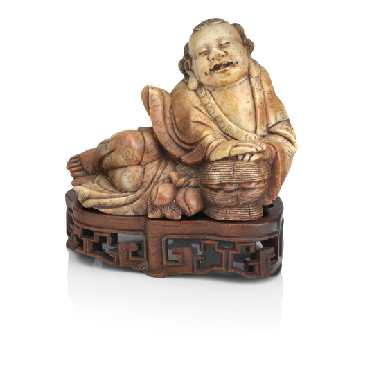 A large soapstone figure of Daoist Immortal on wood stand