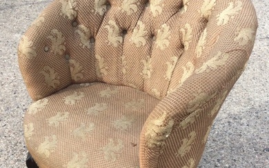 A late Victorian button upholstered tub armchair with rounded back...