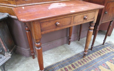 A late Victorian mahogany table having two drawers on turned...