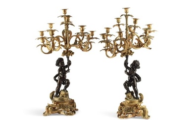 A pair of French gilt and bronze candelabra