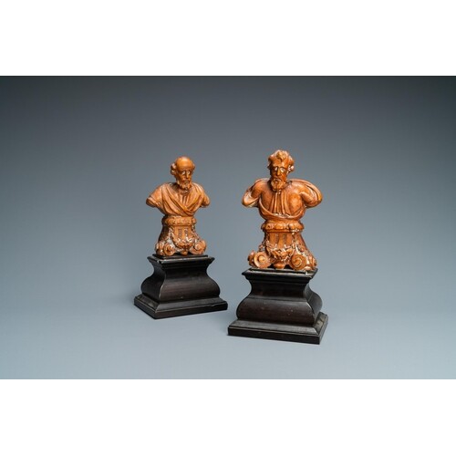 A pair of boxwood busts of a saint on an ebony veneer base, ...