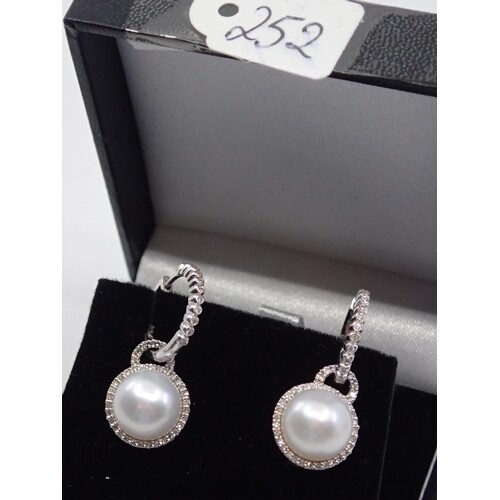 A pair of ladies white gold pearl and diamond earrings