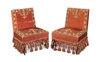 A pair of red velvet and metal thread embroidered slipper chairs