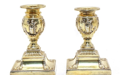 A pair of silver-gilt dwarf candlesticks