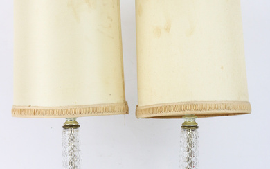 A pair of stylish lamps, featuring a brass and glass...
