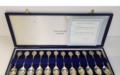 A set of twelve Elizabeth II silver Zodiac spoons by John Pi...