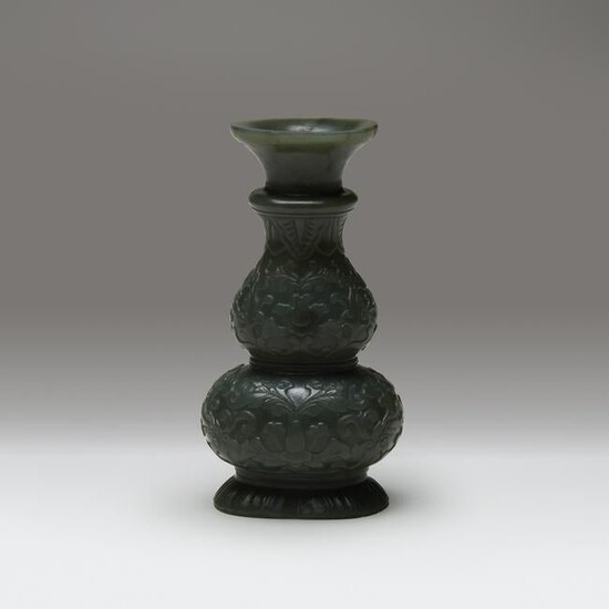 A small Chinese carved spinach jade double-gourd vase