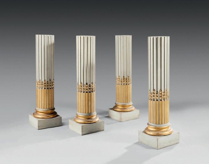 A suite of four moulded, carved and lacquered wood saddles, partially gilded and water-green lacquered, the fluted column with asparagus stem rudentures.