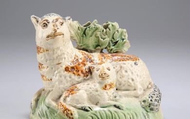 AN EARLY 19TH CENTURY YORKSHIRE POTTERY MODEL OF A EWE AND LAMB