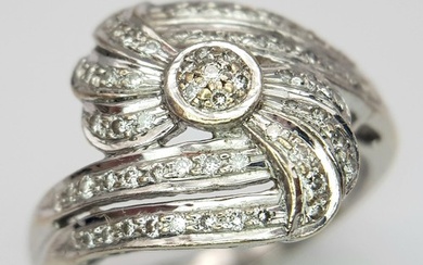 An 18K White Gold Diamond Fancy Crossover Ring. Two encrust...