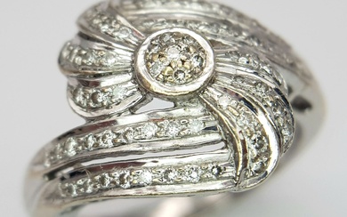 An 18K White Gold Diamond Fancy Crossover Ring. Two...
