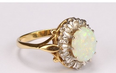 An 18ct gold opal and diamond cluster ring, the central poli...