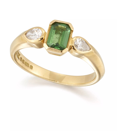 An 18ct gold tsavorite garnet and diamond three stone ring,...