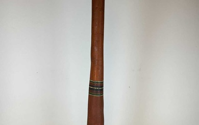 An Aboriginal didgeridoo with three bands of dot painted detail,...