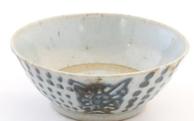 An Oriental earthenware bowl with brushwork detail.
